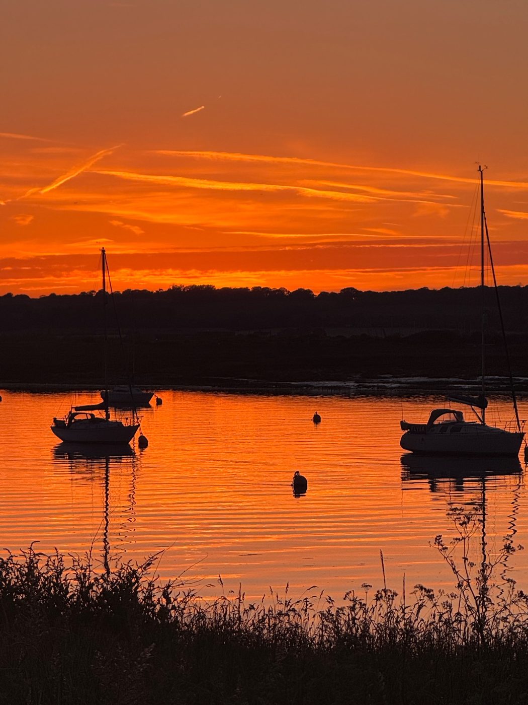 Orange sunset over boats on the River Crouch